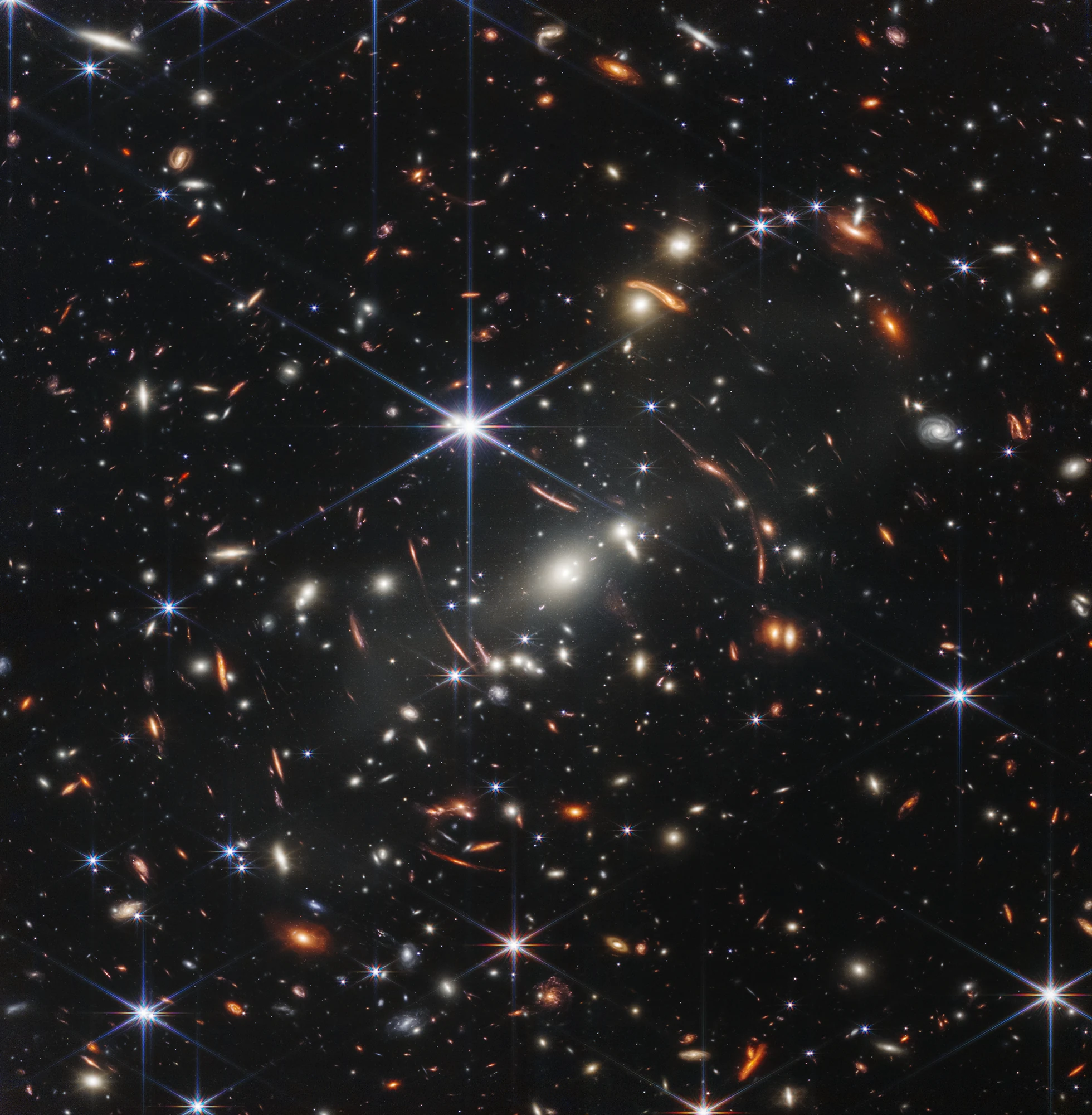 Thousands of distant galaxies and bright blue diffraction spikes in Webb’s first deep field.